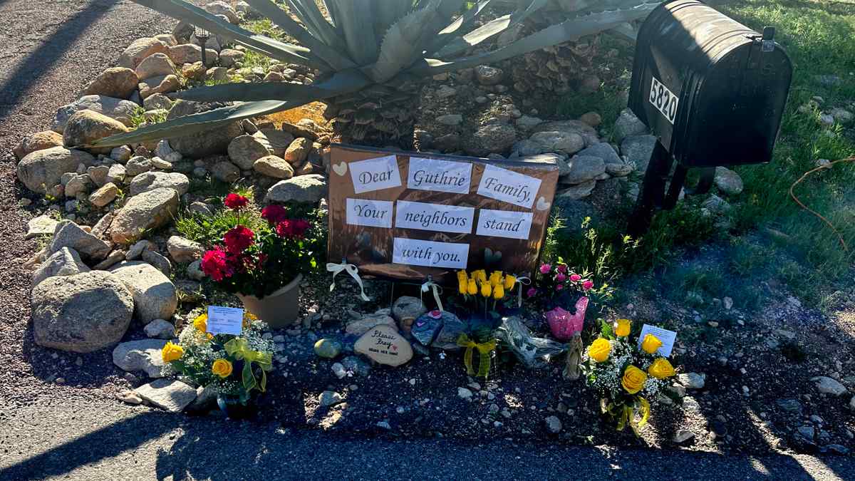 Un altar donde se lee un mensaje 'Querida familia Guthrie, tus vecinos están contigo' frente a la casa de Nancy Guthrie en Catalina Foothills, Arizona. Foto: EFE/María León